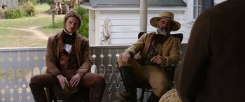 Movie still from “Harriet” (2019), directed by Kasi Lemmons – Two men sitting on the porch of an old house; Medium shot, Low angle