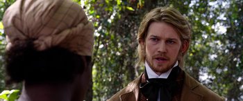 Movie still from “Harriet” (2019), directed by Kasi Lemmons – A person wearing a suit and tie; Close Up shot, Over the shoulder angle