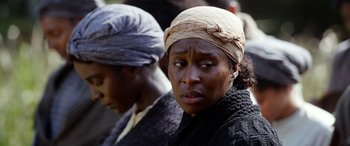 Movie still from “Harriet” (2019), directed by Kasi Lemmons – A woman with a head scarf is sitting next to another woman; Close Up shot, Over the shoulder angle