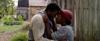 Movie still from “Harriet” (2019), directed by Kasi Lemmons – A man and a woman are holding each other close; Close Up shot, Low angle