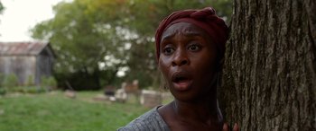 Movie still from “Harriet” (2019), directed by Kasi Lemmons – A woman with a red head scarf is looking surprised; Close Up shot, Low angle
