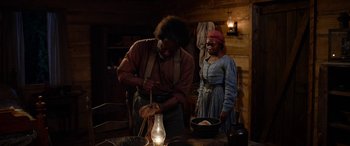 Movie still from “Harriet” (2019), directed by Kasi Lemmons – A man and a woman standing in front of a table; Medium shot, Over the shoulder angle