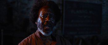 Movie still from “Harriet” (2019), directed by Kasi Lemmons – An older man with a beard and a mustache; Close Up shot, Over the shoulder angle