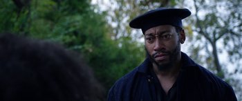 Movie still from “Harriet” (2019), directed by Kasi Lemmons – A man with a beard wearing a hat and glasses; Close Up shot, Over the shoulder angle