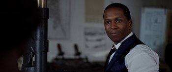 Movie still from “Harriet” (2019), directed by Kasi Lemmons – A person wearing a suit and tie; Close Up shot, Over the shoulder angle