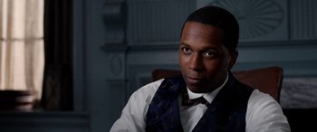 Movie still from “Harriet” (2019), directed by Kasi Lemmons – A man wearing a vest and a bow tie sitting in a chair; Close Up shot, Over the shoulder angle