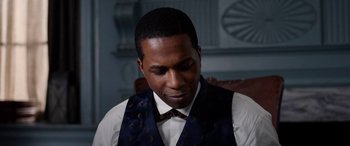 Movie still from “Harriet” (2019), directed by Kasi Lemmons – A man wearing a vest and a bow tie; Close Up shot, Over the shoulder angle