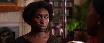 Movie still from “Harriet” (2019), directed by Kasi Lemmons – A person with a book case in the background; Close Up shot, Over the shoulder angle