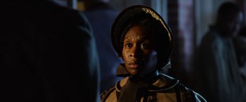 Movie still from “Harriet” (2019), directed by Kasi Lemmons – An african american woman wearing a hat looking at the camera; Close Up shot, Over the shoulder angle