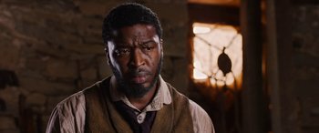 Movie still from “Harriet” (2019), directed by Kasi Lemmons – A man with a beard and a vest looking sad; Close Up shot, Low angle