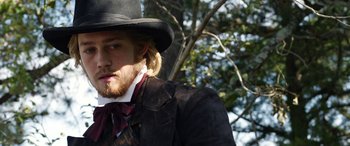 Movie still from “Harriet” (2019), directed by Kasi Lemmons – A man with a long beard wearing a suit and a top hat; Close Up shot, Over the shoulder angle