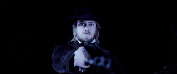 Movie still from “Harriet” (2019), directed by Kasi Lemmons – A man in a black hat holding a pair of guns; Close Up shot, Low angle