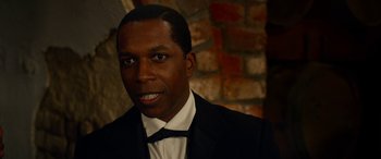 Movie still from “Harriet” (2019), directed by Kasi Lemmons – A person wearing a suit and tie; Close Up shot, Over the shoulder angle