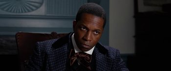 Movie still from “Harriet” (2019), directed by Kasi Lemmons – A person wearing a suit and bow tie; Close Up shot, High angle