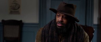 Movie still from “Harriet” (2019), directed by Kasi Lemmons – A man with a beard wearing a brown hat; Close Up shot, Over the shoulder angle