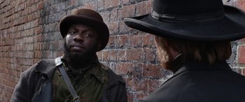 Movie still from “Harriet” (2019), directed by Kasi Lemmons – A man in a hat and a man with a beard; Close Up shot, Over the shoulder angle