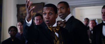 Movie still from “Harriet” (2019), directed by Kasi Lemmons – A man in a suit and tie with a surprised look on his face; Close Up shot, Low angle