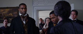 Movie still from “Harriet” (2019), directed by Kasi Lemmons – A group of people standing in a room; Close Up shot, Over the shoulder angle