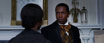 Movie still from “Harriet” (2019), directed by Kasi Lemmons – A man in a suit and tie standing next to another man in a suit; Close Up shot, Over the shoulder angle