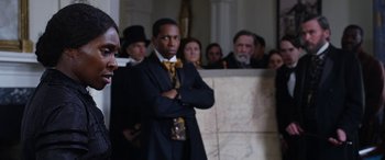 Movie still from “Harriet” (2019), directed by Kasi Lemmons – A group of people standing in a room with a map; Medium shot, Over the shoulder angle