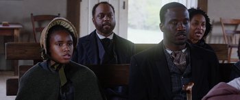 Movie still from “Harriet” (2019), directed by Kasi Lemmons – A group of people sitting in a room; Medium shot, Over the shoulder angle