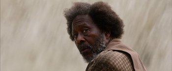 Movie still from “Harriet” (2019), directed by Kasi Lemmons – An older man with a beard and a mustache; Close Up shot, Over the shoulder angle