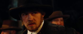 Movie still from “Harriet” (2019), directed by Kasi Lemmons – A man with a beard wearing a black hat; Close Up shot, Over the shoulder angle
