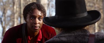 Movie still from “Harriet” (2019), directed by Kasi Lemmons – A person wearing a red shirt and a black hat; Close Up shot, Over the shoulder angle
