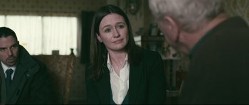 Movie still from “Harry Brown” (2009), directed by Daniel Barber – A woman wearing a suit and a white shirt is talking to a man; Close Up shot, Over the shoulder angle