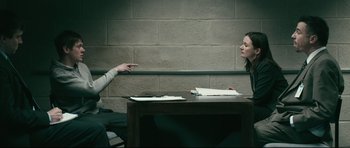Movie still from “Harry Brown” (2009), directed by Daniel Barber – Two people sitting at a table in a room; Medium shot, Over the shoulder angle