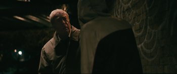 Movie still from “Harry Brown” (2009), directed by Daniel Barber – An older man standing next to a basketball hoop; Close Up shot, Over the shoulder angle