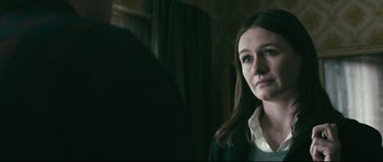 Movie still from “Harry Brown” (2009), directed by Daniel Barber – A woman standing next to a man in a room; Close Up shot, Over the shoulder angle