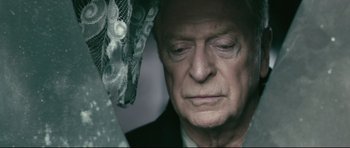Movie still from “Harry Brown” (2009), directed by Daniel Barber – An older man with a sad look on his face; Close Up shot, High angle