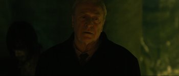 Movie still from “Harry Brown” (2009), directed by Daniel Barber – An older man in a black jacket and tie; Close Up shot, Low angle