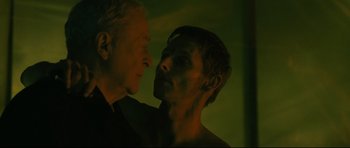 Movie still from “Harry Brown” (2009), directed by Daniel Barber – A man and a woman face to face in a dark room; Close Up shot, Over the shoulder angle