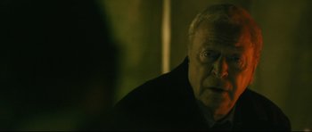 Movie still from “Harry Brown” (2009), directed by Daniel Barber – An older man is looking at the camera; Close Up shot, Over the shoulder angle