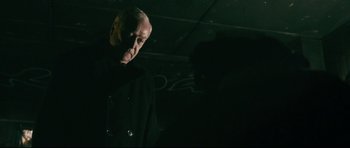 Movie still from “Harry Brown” (2009), directed by Daniel Barber – An older man standing in a dark room; Close Up shot, Over the shoulder angle