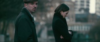 Movie still from “Harry Brown” (2009), directed by Daniel Barber – A man and a woman are standing next to each other; Medium shot, Over the shoulder angle