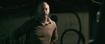 Movie still from “Harry Brown” (2009), directed by Daniel Barber – A man in a brown sweater looking at the camera; Close Up shot, Over the shoulder angle