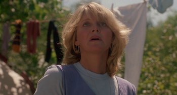 Movie still from “Harry and the Hendersons” (1987), directed by William Dear – A person looking up at the sky; Close Up shot, Low angle