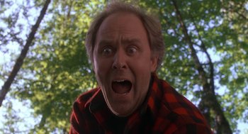 Movie still from “Harry and the Hendersons” (1987), directed by William Dear – A person wearing a red and black shirt; Close Up shot, Low angle