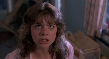 Movie still from “Harry and the Hendersons” (1987), directed by William Dear – A young woman is looking at the camera; Close Up shot, Low angle