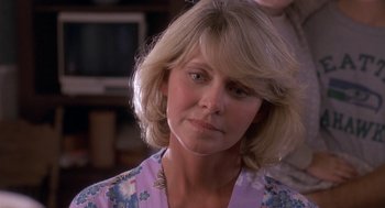 Movie still from “Harry and the Hendersons” (1987), directed by William Dear – A person with blonde hair; Close Up shot, Over the shoulder angle