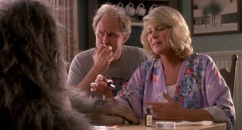 Movie still from “Harry and the Hendersons” (1987), directed by William Dear – A man and a woman sitting at a table; Close Up shot, Over the shoulder angle