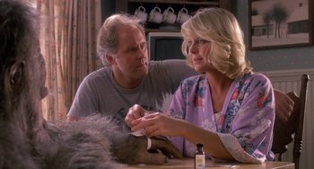 Movie still from “Harry and the Hendersons” (1987), directed by William Dear – An older man and a younger woman sitting at a table; Close Up shot, Over the shoulder angle