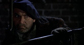 Movie still from “Harry and the Hendersons” (1987), directed by William Dear – A man with a beard wearing a hat and a jacket; Close Up shot, Low angle