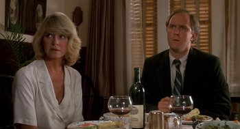 Movie still from “Harry and the Hendersons” (1987), directed by William Dear – A man and a woman sitting at a dinner table; Close Up shot, Low angle