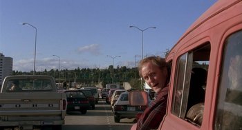 Movie still from “Harry and the Hendersons” (1987), directed by William Dear – A man leaning out of the window of a car; Medium shot, Over the shoulder angle