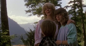 Movie still from “Harry and the Hendersons” (1987), directed by William Dear – A woman standing next to two young children; Medium shot, Over the shoulder angle