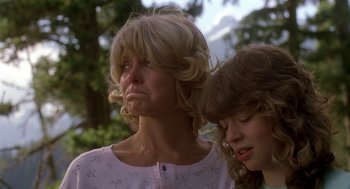 Movie still from “Harry and the Hendersons” (1987), directed by William Dear – A woman and a girl looking sad while standing next to each other; Close Up shot, Low angle